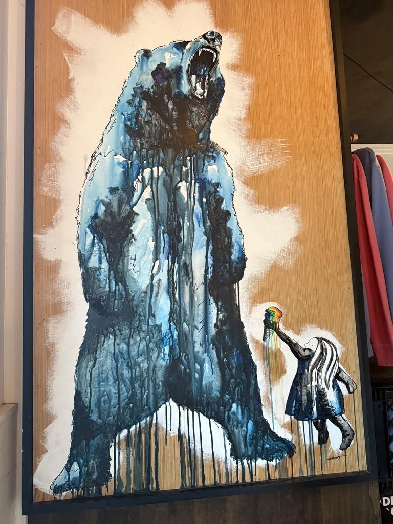 Painting of a roaring bear and a girl with an ice cream cone